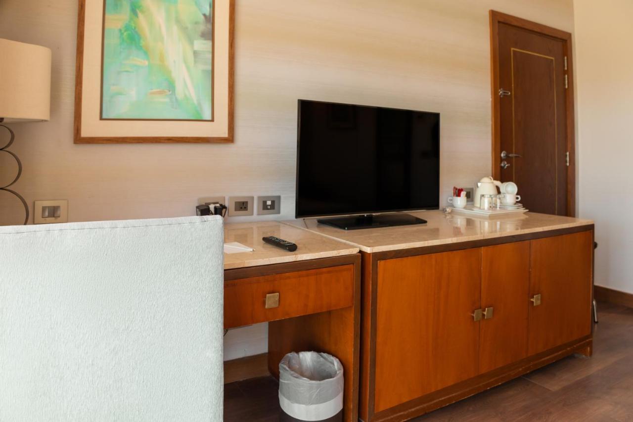 Hotel Sharm Dreams Vacation Club - Aqua Park Exterior foto A television in a hotel room